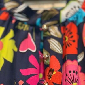 Trina Turk dress short, navy background with bright flowers in pinks and greens